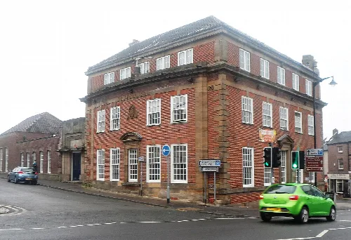 Red brick hotel with white windows in Burslem, Staffordshire.