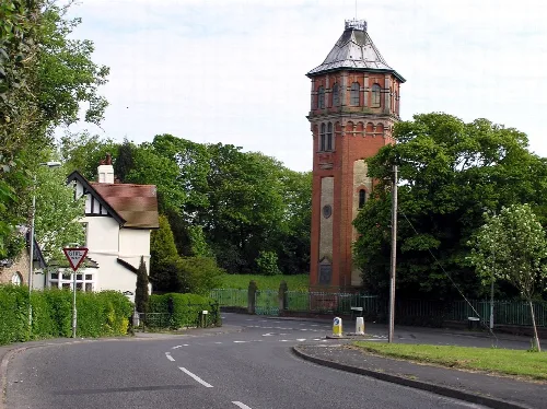 Water tower and white house with gabled roof in Gainsborough.