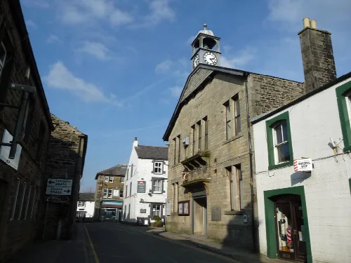 Stone town hall with clock tower on Station Road in High Bentham.