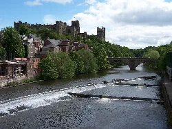 River Wear with bridges, trees, and historic buildings in Durham.