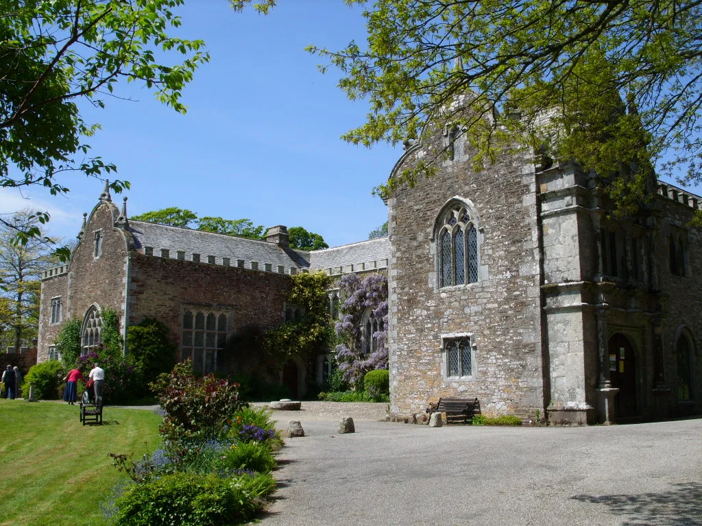 Stone hall with gothic windows and gardens in Cornwall.
