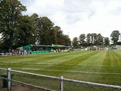 Football pitch with main stand and spectators at Top Field in Hitchin.