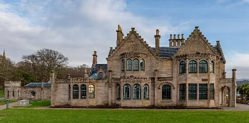 A large stone building with turrets and many windows in Millport.