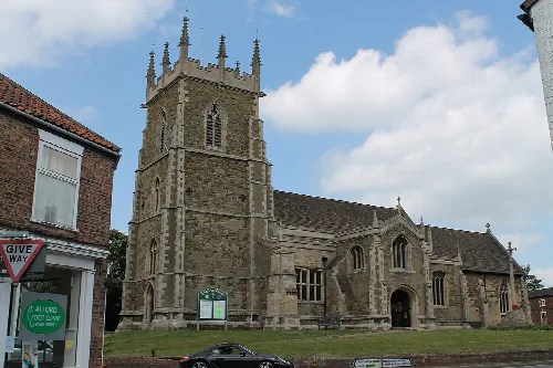 Stone church with a tall tower and gothic windows in Alford.