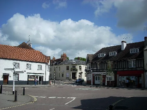 View of the centre of Whitchurch with buildings and a cloudy sky.