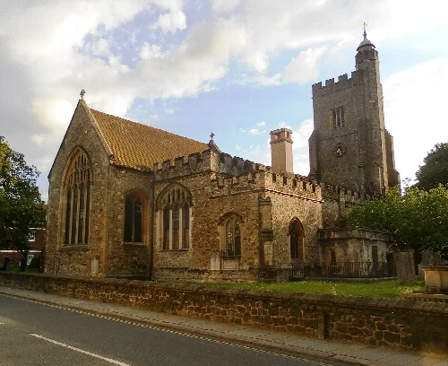 Stone church with a tall tower and arched windows in Sevenoaks.