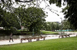 Park with trees, benches, and a fountain in Stevenage town centre.