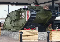 A green British Mark IV female tank with the number 245 on its side, displayed outdoors with a canopy.