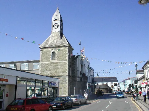 Stone clock tower with a pointed roof in Wadebridge, Cornwall.