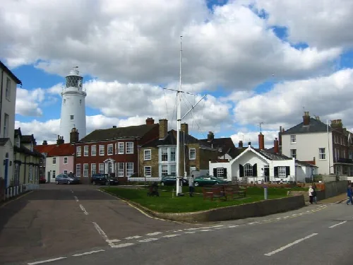 Lighthouse, houses, and a small park on North Parade in Southwold.