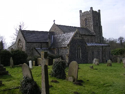 Stone church with graveyard and tombstones in front.
