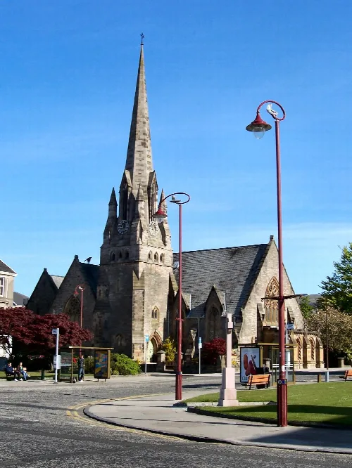 Stone church with tall spire and gothic windows in Helensburgh.
