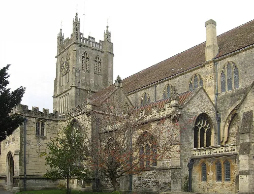 Stone church with a tall tower and arched windows in Dursley.