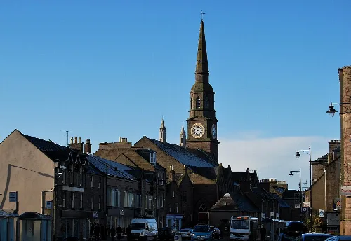 View of Forfar High Street with church and buildings.