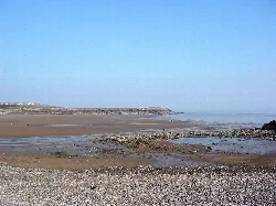Sandy beach and calm sea at Watchtower Bay in Barry.