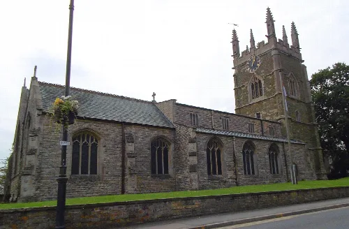 Stone church with a tall tower and gothic windows in Spilsby.