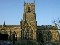 Iglesia de piedra con ventanas altas y torre en Bridport.