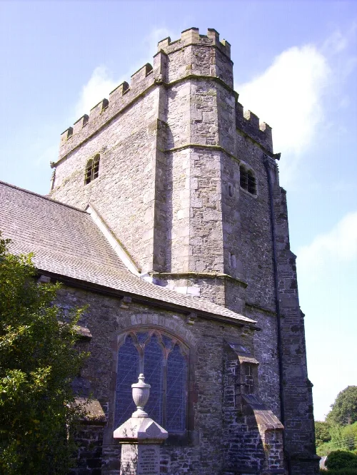 Stone church tower with battlements and arched windows in Llantrisant.
