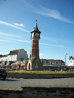 A tall clock tower with a pointed roof in Skegness.
