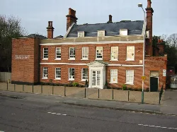Brick building with white windows and a small porch in Hornchurch.